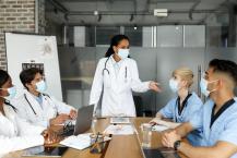 Doctors in protective masks in conference